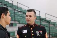 Senior editor Matthew White interviews Marine Corps Staff Sergeant Brian Lister before the veterans assembly