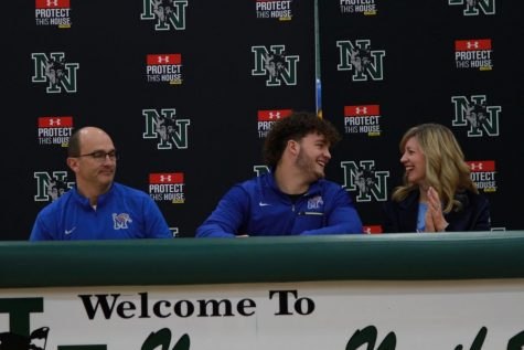 Cole Mashburn celebrates with his parents after signing with the University of Memphis to play football.