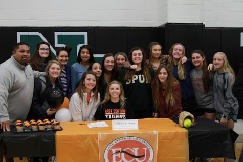 Catcher and shortstop, Adrianna Swan, congratulated by the Norman North Softball Team as she signs with East Central University.