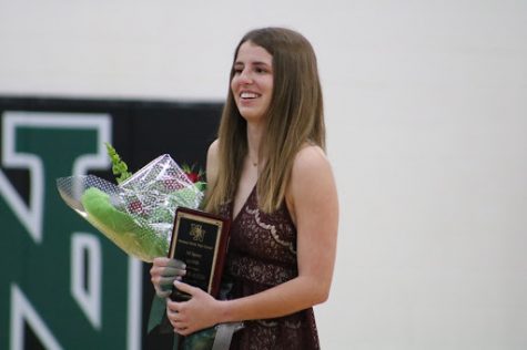 Allison Austin with her plaque and bouquet of flowers