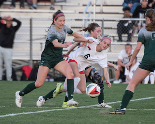 Annabella Potts and Meredith McAlester put a hard tackle on the Westmoore attacker.