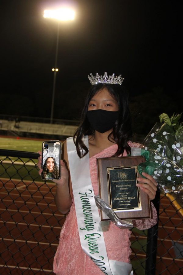Junior Brandy Liu, holding a phone while on a facetime call with Makenzie Toma, Homecoming Queen.