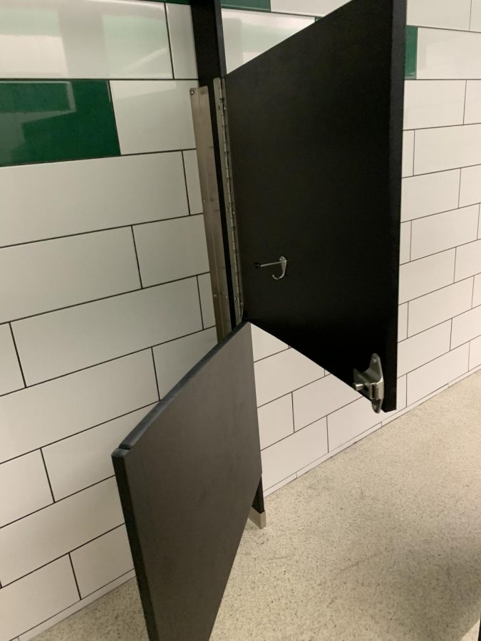 Stall door ripped in half in the South Hall 100 Hallway Bathroom.