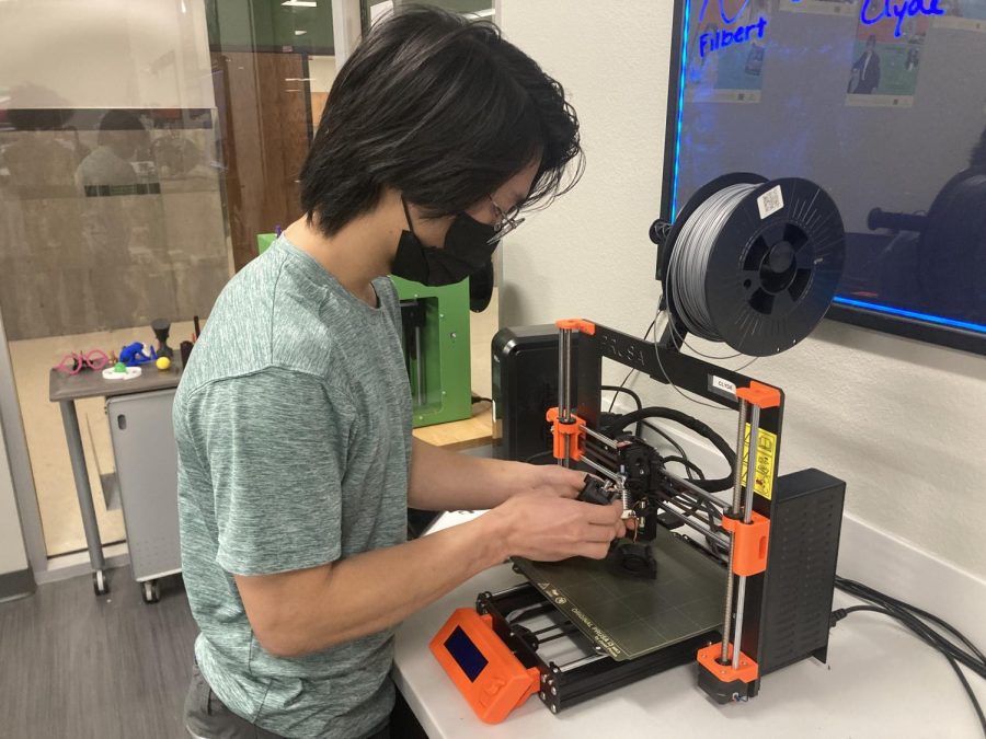 iTech Assistant, Joshua Khor fixing a 3D Printer. 
