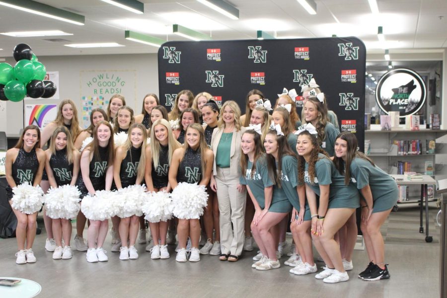 Dr. Garrett poses with members of pom and cheer in May 2021.