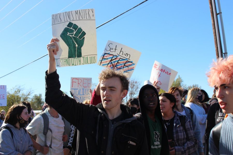 A student holds up a sign stating Black Lives Matter.