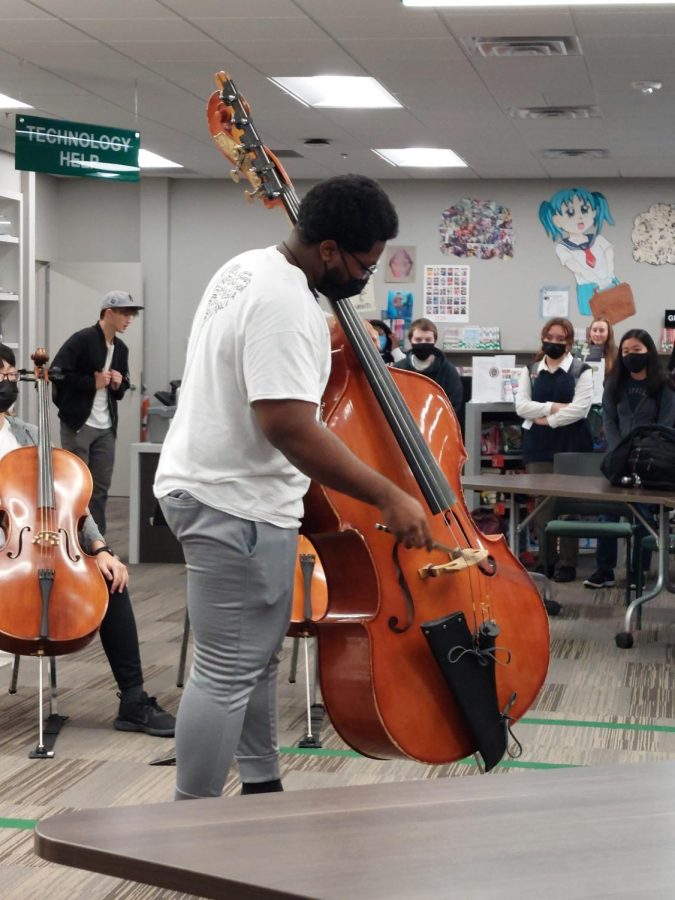 Kalizble Okoya (senior) playing the bass during a performance during Fine Arts Week.