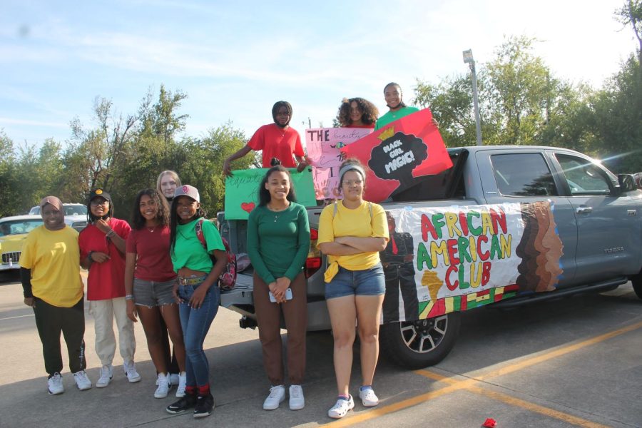 The African American Association poses for a photo in front of their float for the Homecoming Parade. 