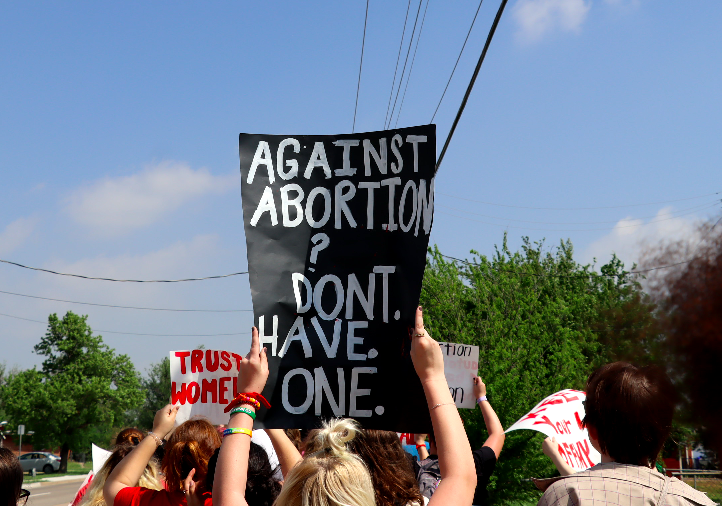 A student holding a sign in support of abortion rights. 