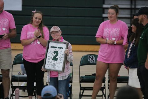 Dr. Hill accepts an award at the Pinkout volleyball game.