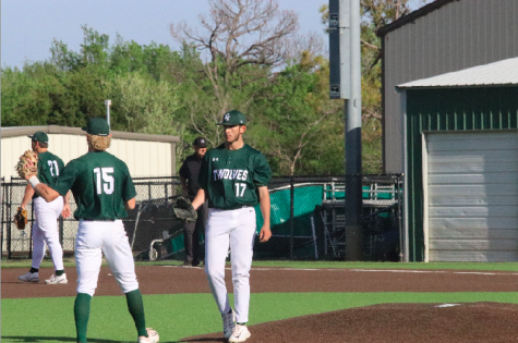 Number 17, junior, Spencer Ille, walks off the mound after a successful pitch.